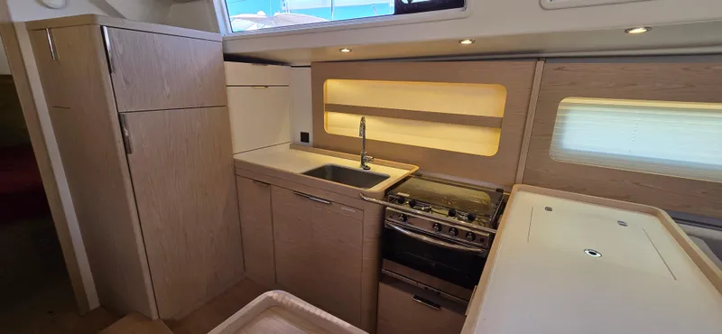 Wildflower Yacht Photos Pics Modern kitchen in 2021 Beneteau Oceanis Yacht 54 with sleek cabinetry and appliances.