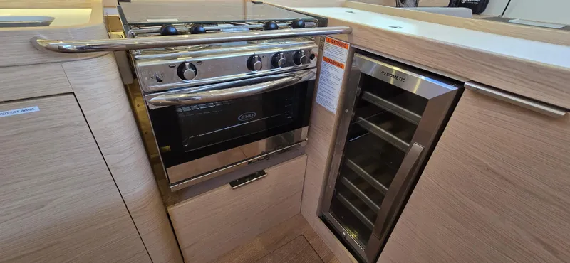 Wildflower Yacht Photos Pics Modern kitchen in 2021 Beneteau Oceanis Yacht 54 with oven and wine cooler.