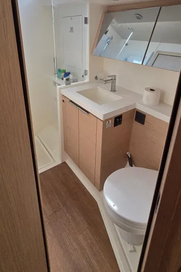 Wildflower Yacht Photos Pics Modern bathroom in 2021 Beneteau Oceanis Yacht 54, featuring sleek fixtures and wood accents.
