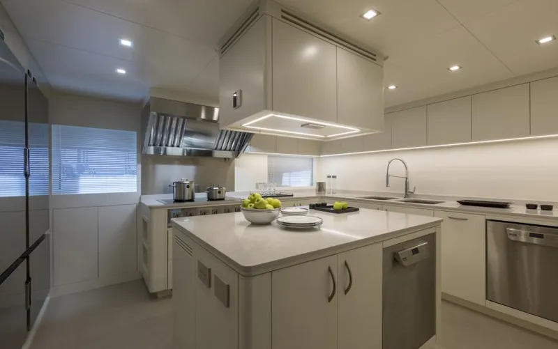  Yacht Photos Pics Luxurious modern kitchen on 2022 Mangusta 165 REV yacht, featuring sleek design and stainless steel appliances.