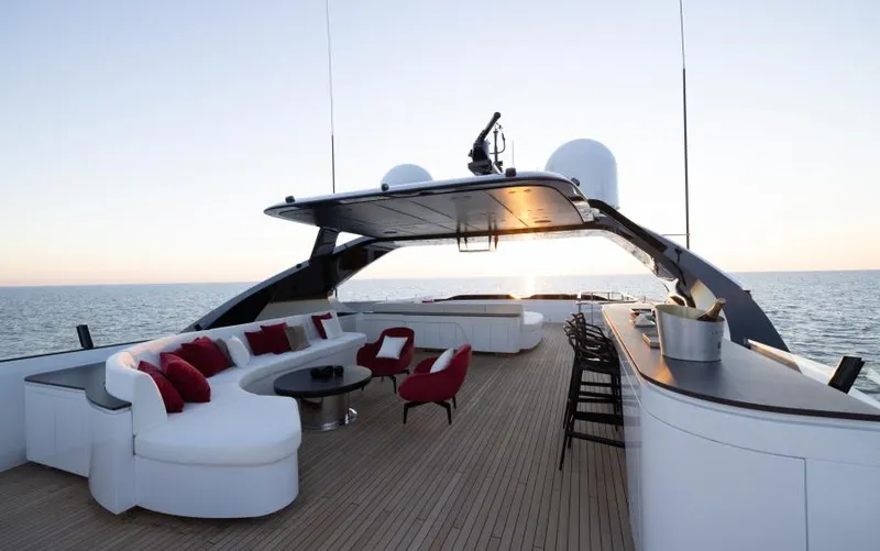  Yacht Photos Pics Luxurious 2022 Mangusta 165 REV yacht deck with elegant seating and ocean view.