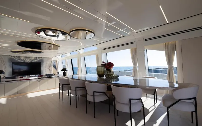  Yacht Photos Pics Luxurious interior of 2022 Mangusta 165 REV yacht with elegant dining area and ocean view.