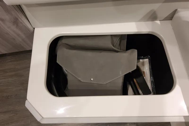  Yacht Photos Pics Storage compartment in 2026 Formula 400 Super Sport Crossover, featuring a gray bag and accessories.