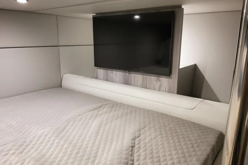  Yacht Photos Pics Luxurious interior of 2026 Formula 400 Super Sport Crossover with TV and comfortable bedding.