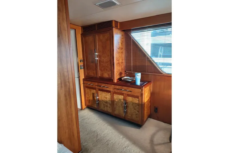 Capricho Yacht Photos Pics Luxurious wood interior of 1987 Burger Motoryacht with cabinets and window blinds.