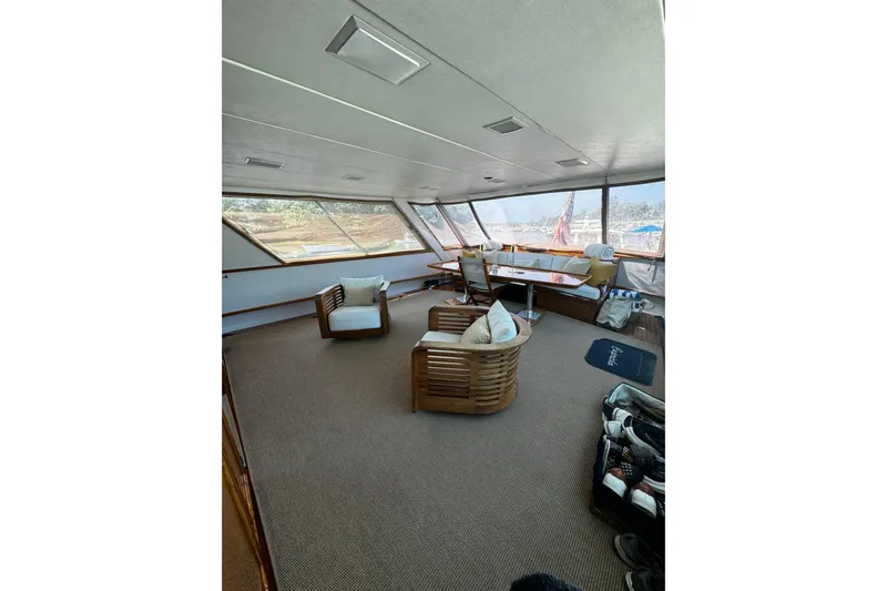 Capricho Yacht Photos Pics Interior of 1987 Burger Motoryacht with seating area and large windows.