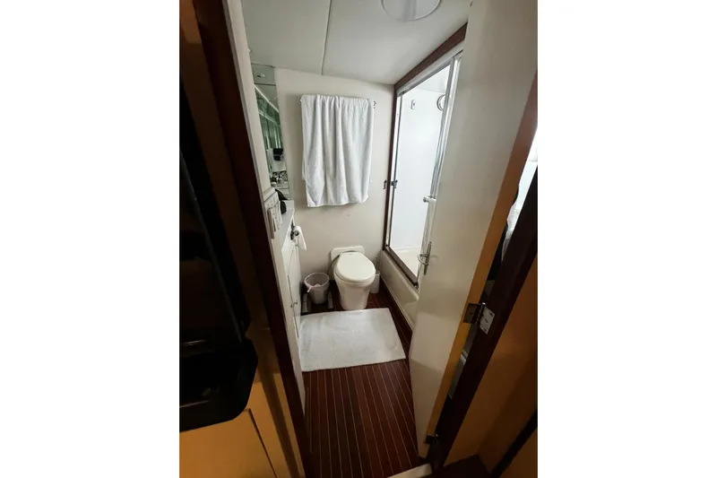 Capricho Yacht Photos Pics Bathroom interior of a 1987 Burger Motoryacht with shower and toilet.