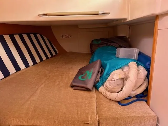 Valanta Yacht Photos Pics Cozy cabin interior of 2007 Hanse 400 sailboat with striped cushion and bedding.