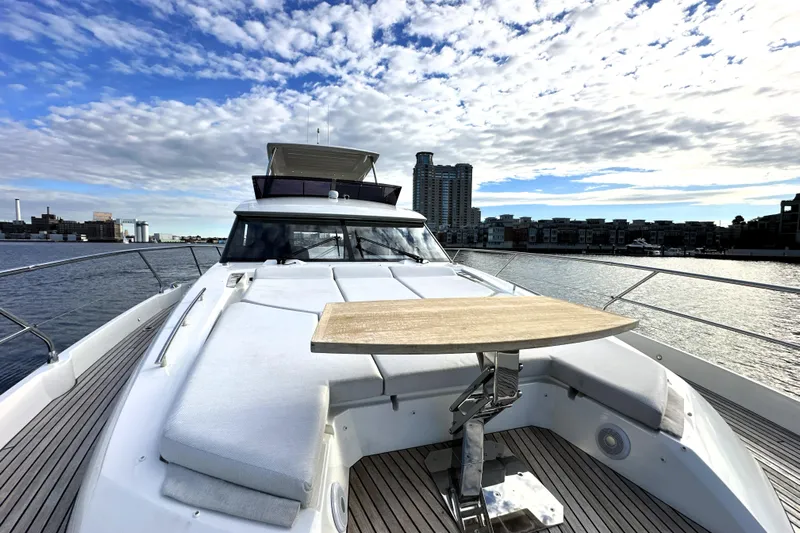 Highland Patriot Yacht Photos Pics 2023 Prestige 590 yacht on water, featuring spacious deck and modern design.