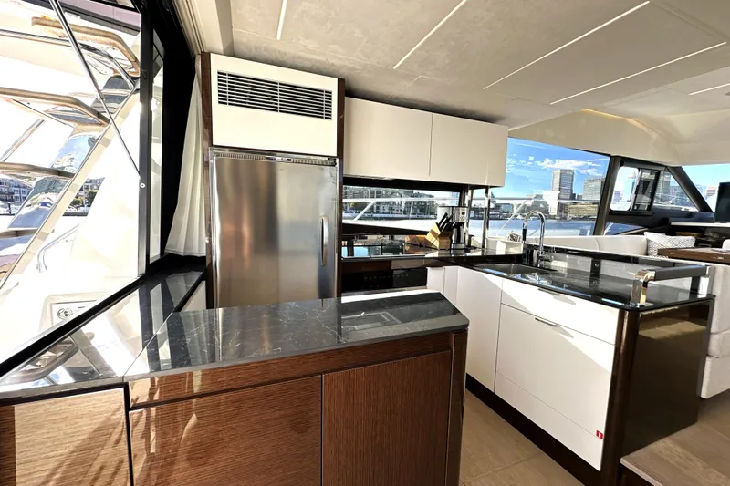 Highland Patriot Yacht Photos Pics Luxurious kitchen interior of 2023 Prestige 590 yacht with modern appliances and sleek design.