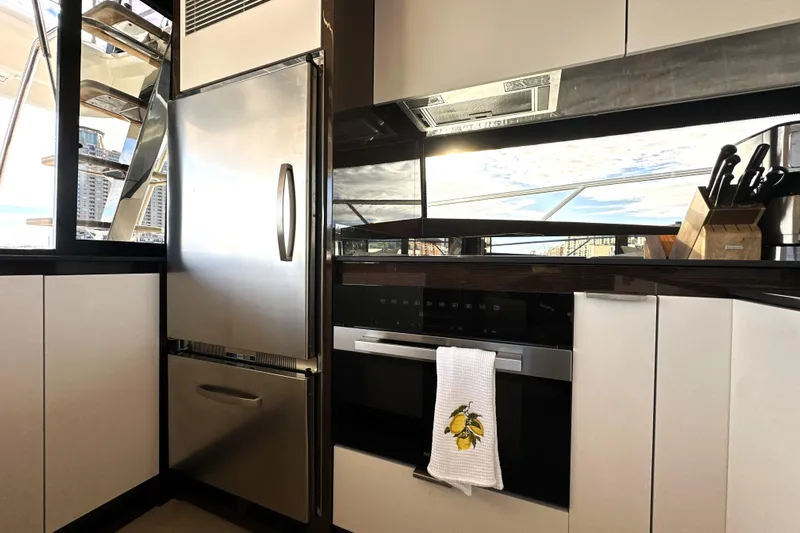 Highland Patriot Yacht Photos Pics Modern kitchen interior on 2023 Prestige 590 yacht with stainless steel appliances.