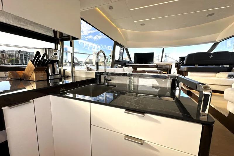 Highland Patriot Yacht Photos Pics Luxurious kitchen interior of 2023 Prestige 590 yacht with modern amenities and sleek design.