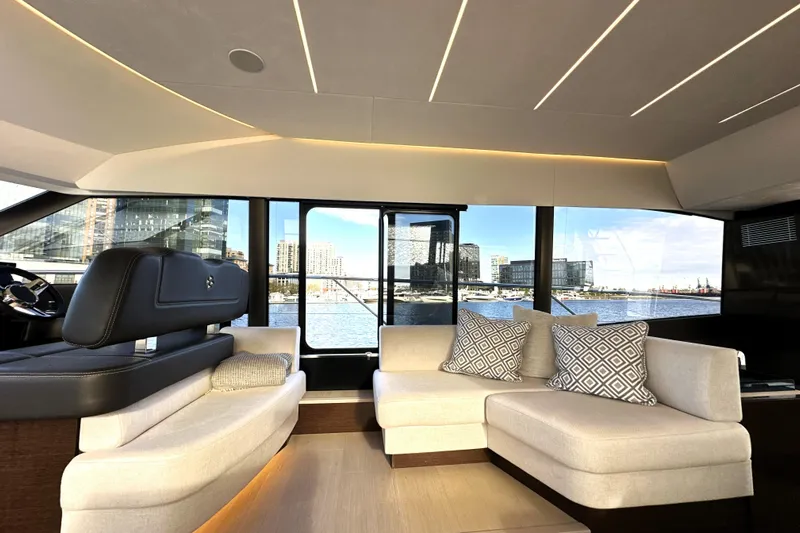 Highland Patriot Yacht Photos Pics Luxurious interior of 2023 Prestige 590 yacht with modern seating and waterfront view.