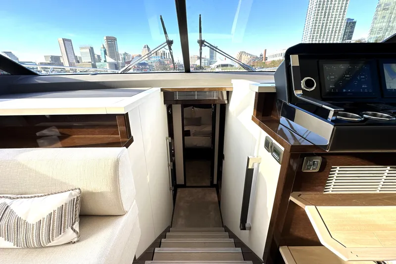 Highland Patriot Yacht Photos Pics Interior of 2023 Prestige 590 yacht with modern helm and city skyline view.