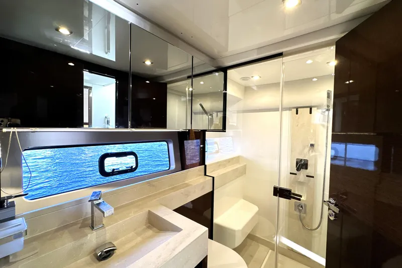 Highland Patriot Yacht Photos Pics Luxurious bathroom interior of 2023 Prestige 590 yacht with modern fixtures and ocean view.
