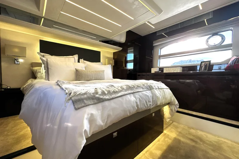 Highland Patriot Yacht Photos Pics Luxurious bedroom interior of 2023 Prestige 590 yacht with elegant bedding and modern design.