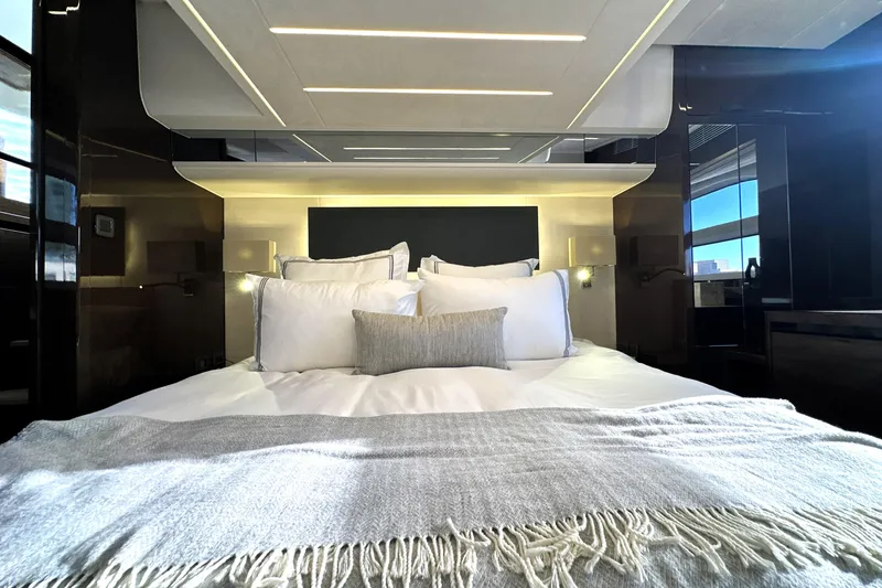 Highland Patriot Yacht Photos Pics Luxurious bedroom interior of 2023 Prestige 590 yacht with elegant bedding and modern design.