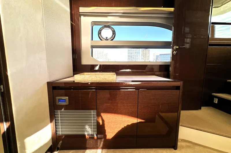 Highland Patriot Yacht Photos Pics Luxurious interior of 2023 Prestige 590 yacht with sleek wood cabinetry and modern window design.