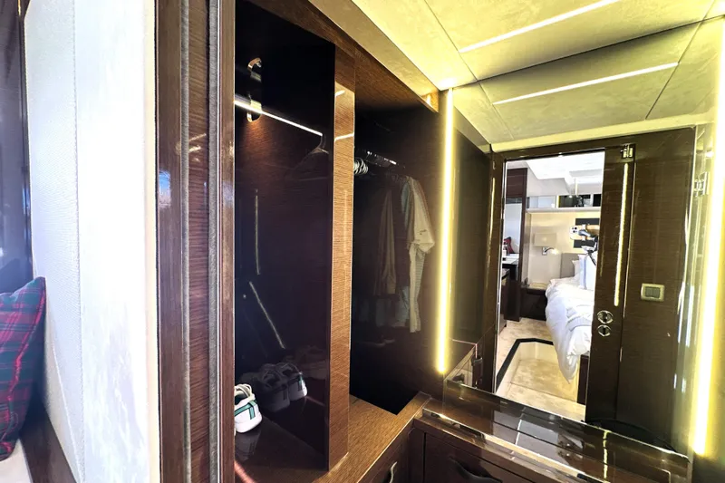 Highland Patriot Yacht Photos Pics Luxurious interior of 2023 Prestige 590 yacht featuring elegant wood finishes and modern lighting.