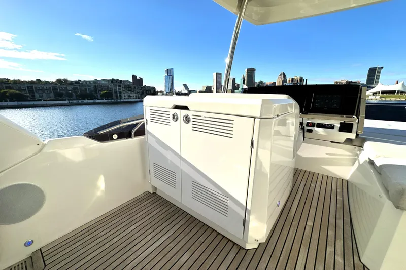 Highland Patriot Yacht Photos Pics Luxurious 2023 Prestige 590 yacht deck with city skyline view.