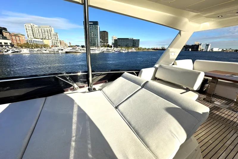 Highland Patriot Yacht Photos Pics Luxurious 2023 Prestige 590 yacht with spacious deck, city skyline view, and waterfront marina.