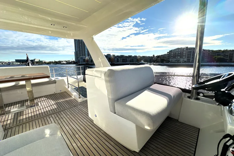 Highland Patriot Yacht Photos Pics Luxurious 2023 Prestige 590 yacht interior with waterfront view and elegant seating.
