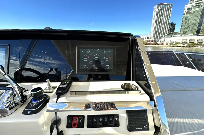 Highland Patriot Yacht Photos Pics 2023 Prestige 590 yacht helm with modern controls and cityscape background.