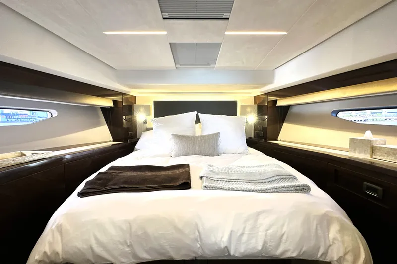 Highland Patriot Yacht Photos Pics Luxurious bedroom interior of 2023 Prestige 590 yacht with elegant bedding and modern design.