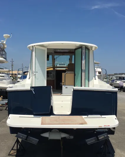  Yacht Photos Pics 2026 Back Cove 372 yacht, rear view, docked under clear blue sky.