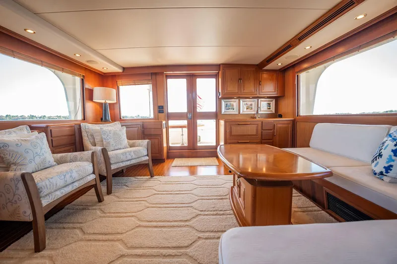 Beba Yacht Photos Pics Luxurious interior of 2003 Fleming 75 yacht with elegant wood finishes and plush seating.