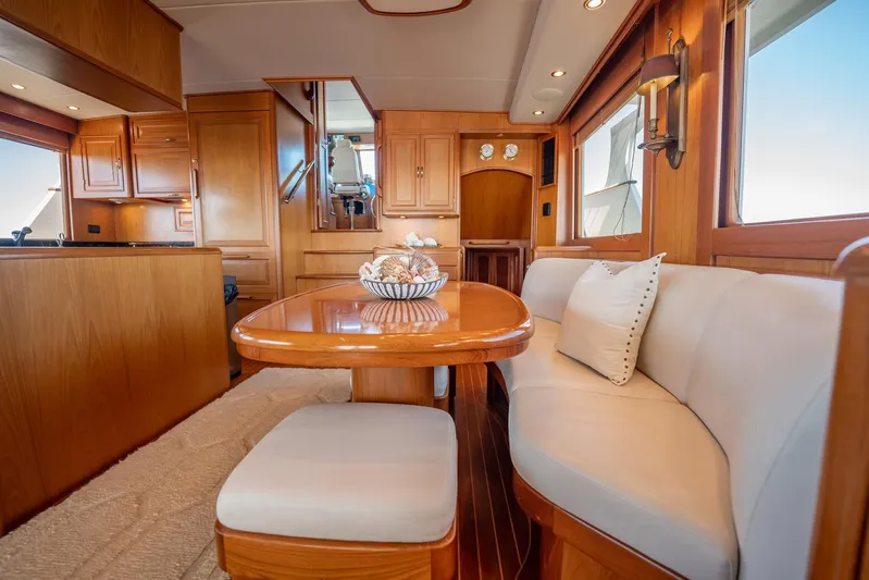 Beba Yacht Photos Pics Luxurious interior of a 2003 Fleming 75 yacht with elegant wood finishes and cozy seating.