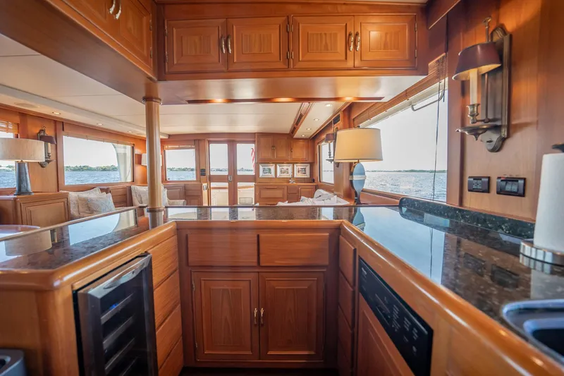 Beba Yacht Photos Pics Luxurious interior of a 2003 Fleming 75 yacht with wooden cabinetry and ocean view.