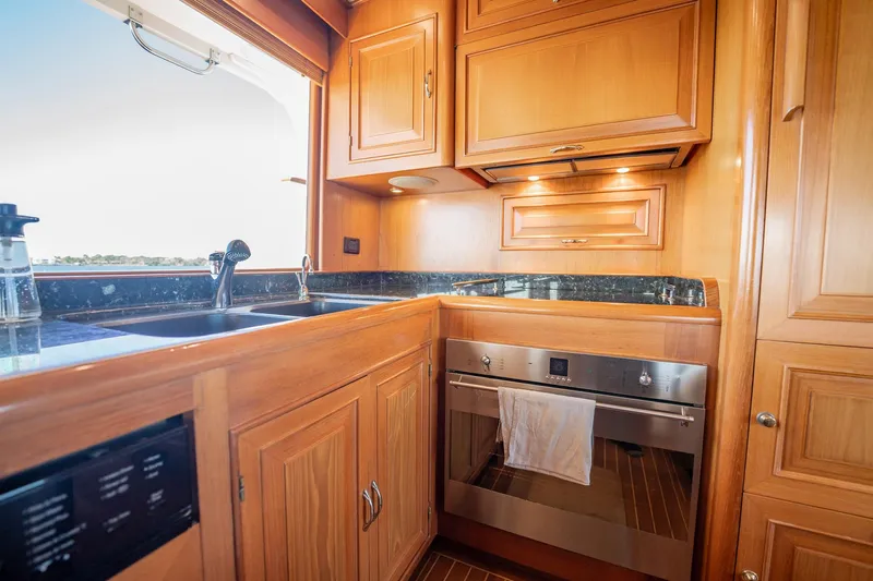Beba Yacht Photos Pics Luxurious wooden kitchen interior on a 2003 Fleming 75 yacht.
