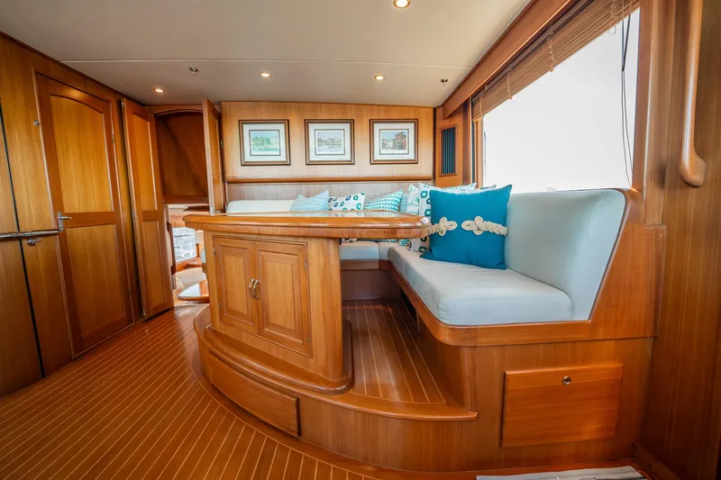 Beba Yacht Photos Pics Luxurious 2003 Fleming 75 yacht interior with wooden finishes and cozy seating area.