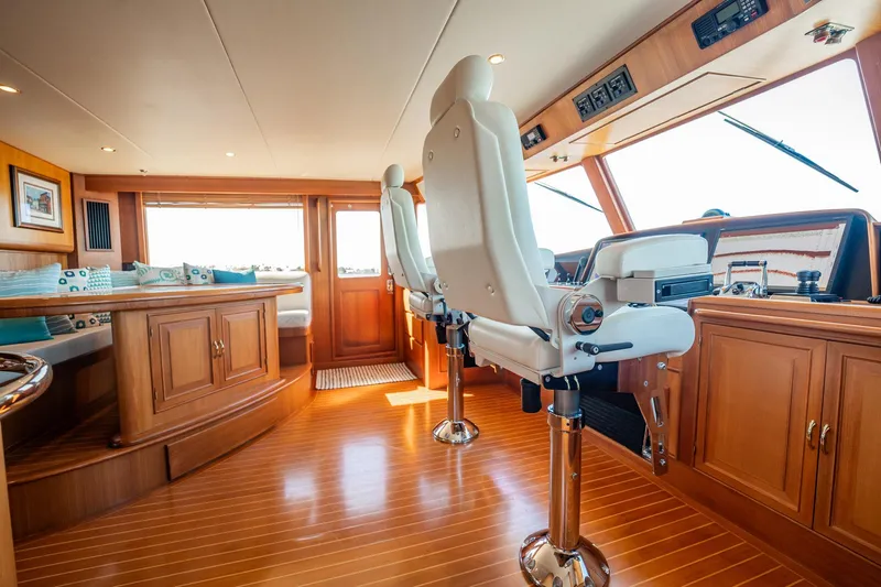 Beba Yacht Photos Pics Luxurious interior of a 2003 Fleming 75 yacht with polished wood and plush seating.
