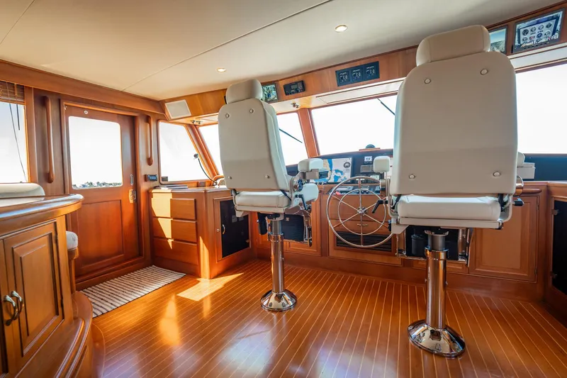 Beba Yacht Photos Pics Luxurious 2003 Fleming 75 yacht interior with polished wood and modern helm chairs.