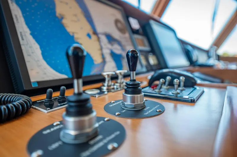 Beba Yacht Photos Pics Control panel of a 2003 Fleming 75 yacht with navigation screen and joysticks.
