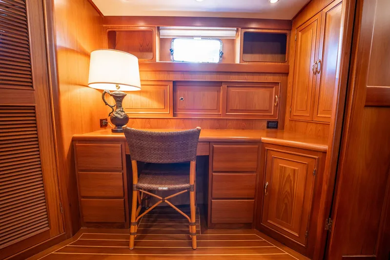 Beba Yacht Photos Pics Luxurious wooden cabin interior with desk and chair on a 2003 Fleming 75 yacht.