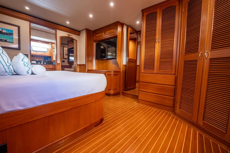 Beba Yacht Photos Pics Luxurious wooden interior of a 2003 Fleming 75 yacht bedroom with elegant furnishings.