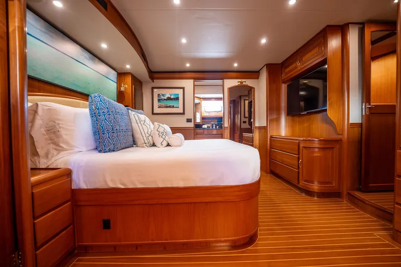Beba Yacht Photos Pics Luxurious cabin interior of 2003 Fleming 75 yacht with elegant wood finish and cozy bedding.