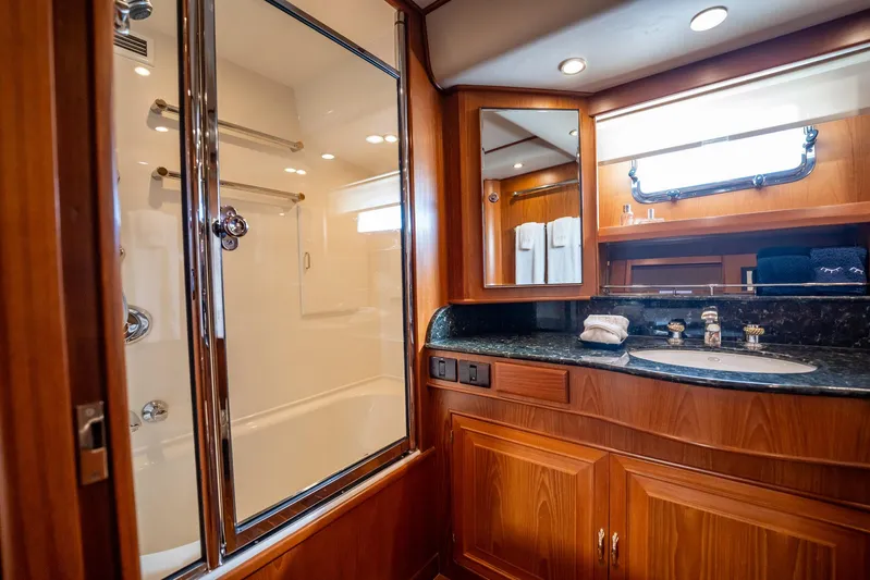 Beba Yacht Photos Pics Luxurious bathroom in 2003 Fleming 75 yacht with wood cabinetry and glass shower.