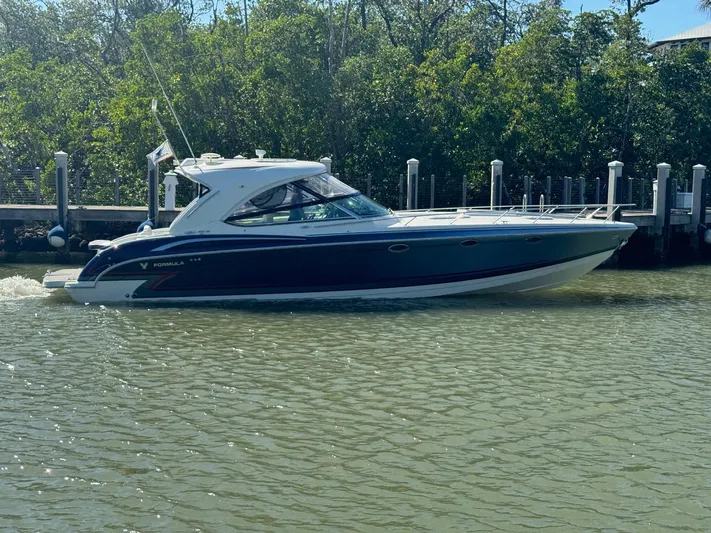 Sonatella Yacht Photos Pics 2017 Formula 400 Super Sport boat cruising near a dock.