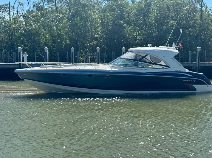 Sonatella Yacht Photos Pics 2017 Formula 400 Super Sport boat docked in a serene waterway.