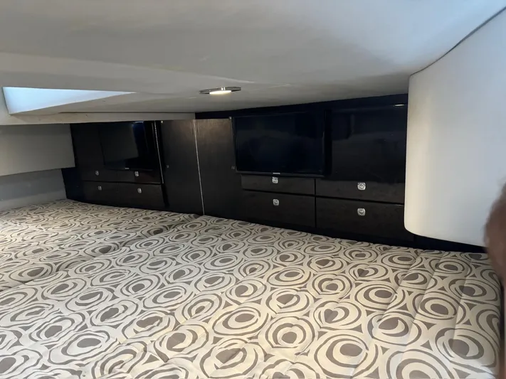 Sonatella Yacht Photos Pics Interior of 2017 Formula 400 Super Sport yacht with patterned bedding and sleek cabinetry.