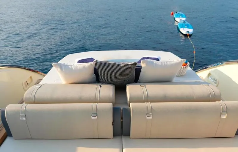 Montenegrina Yacht Photos Pics Invictus TT460 yacht 2023, luxurious seating area overlooking calm sea with small boats.