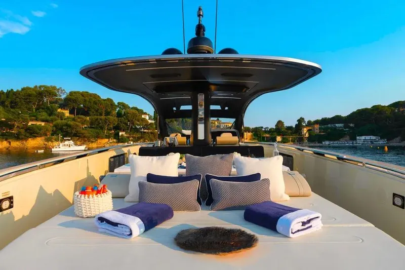Montenegrina Yacht Photos Pics Luxurious 2023 Invictus TT460 yacht deck with plush seating and scenic coastal view.