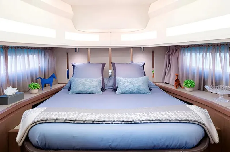 Montenegrina Yacht Photos Pics Luxurious bedroom interior of 2023 Invictus TT460 yacht with elegant decor and soft lighting.