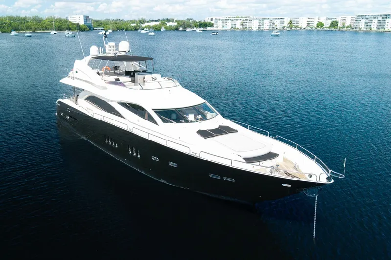 Sukha Yacht Photos Pics Luxurious 2008 Sunseeker 90 Yacht cruising on serene waters.