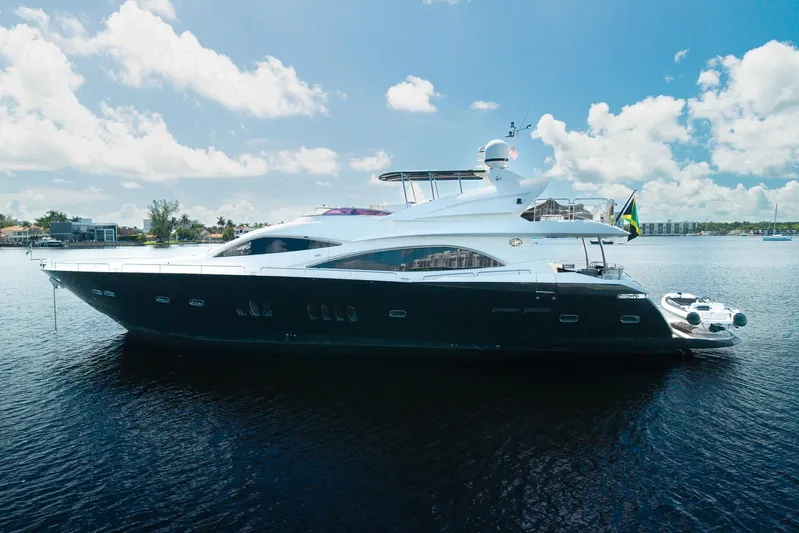 Sukha Yacht Photos Pics 2008 Sunseeker 90 Yacht on calm water under a clear blue sky.