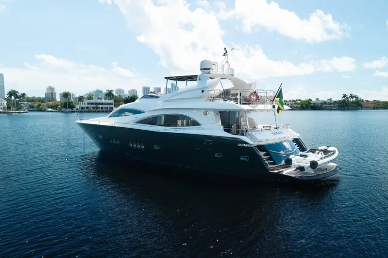 Sukha Yacht Photos Pics 2008 Sunseeker 90 Yacht on calm water, featuring sleek design and luxury amenities.